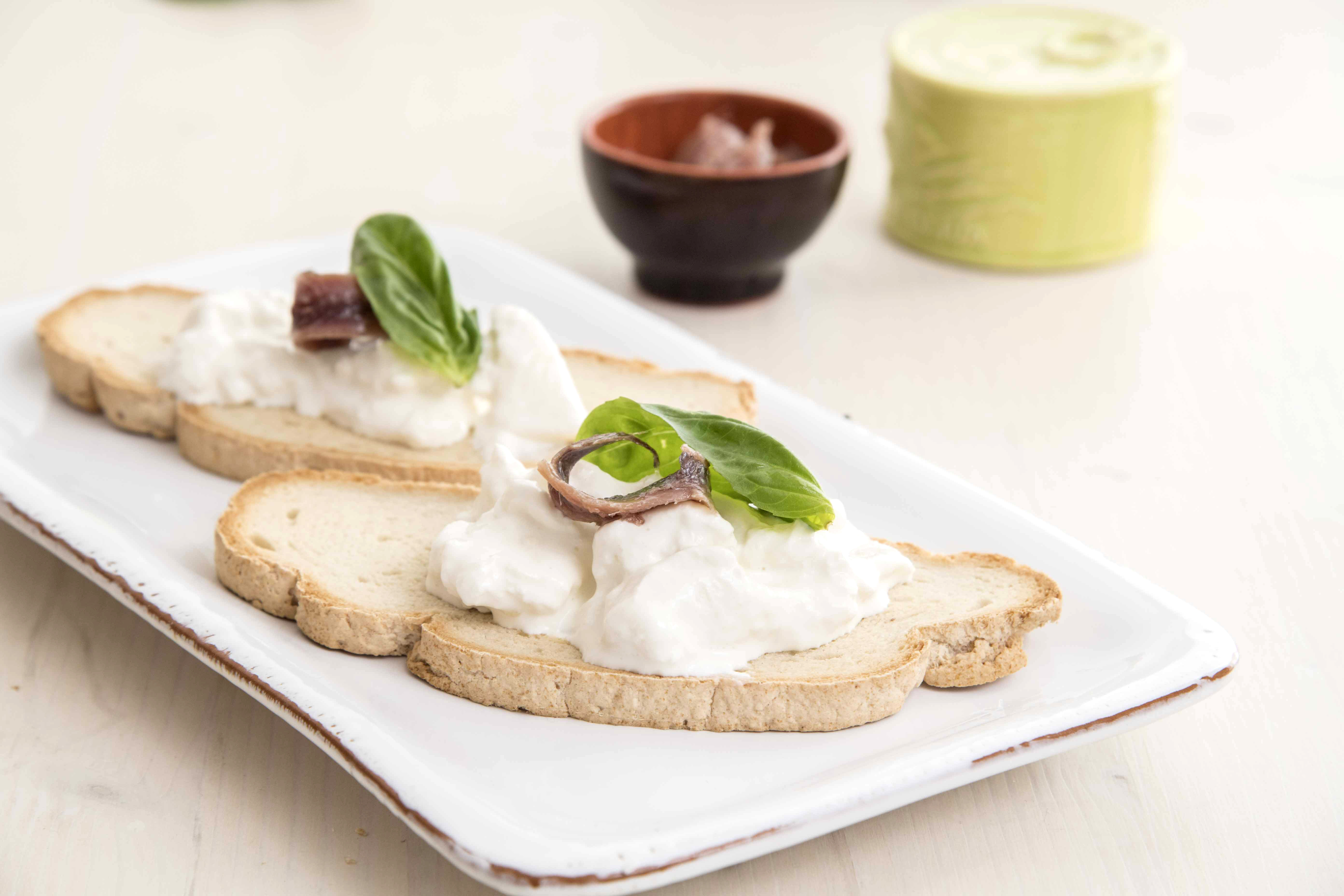 Gluten-free bruschetta with stracciatella and Sciacca alice fillets