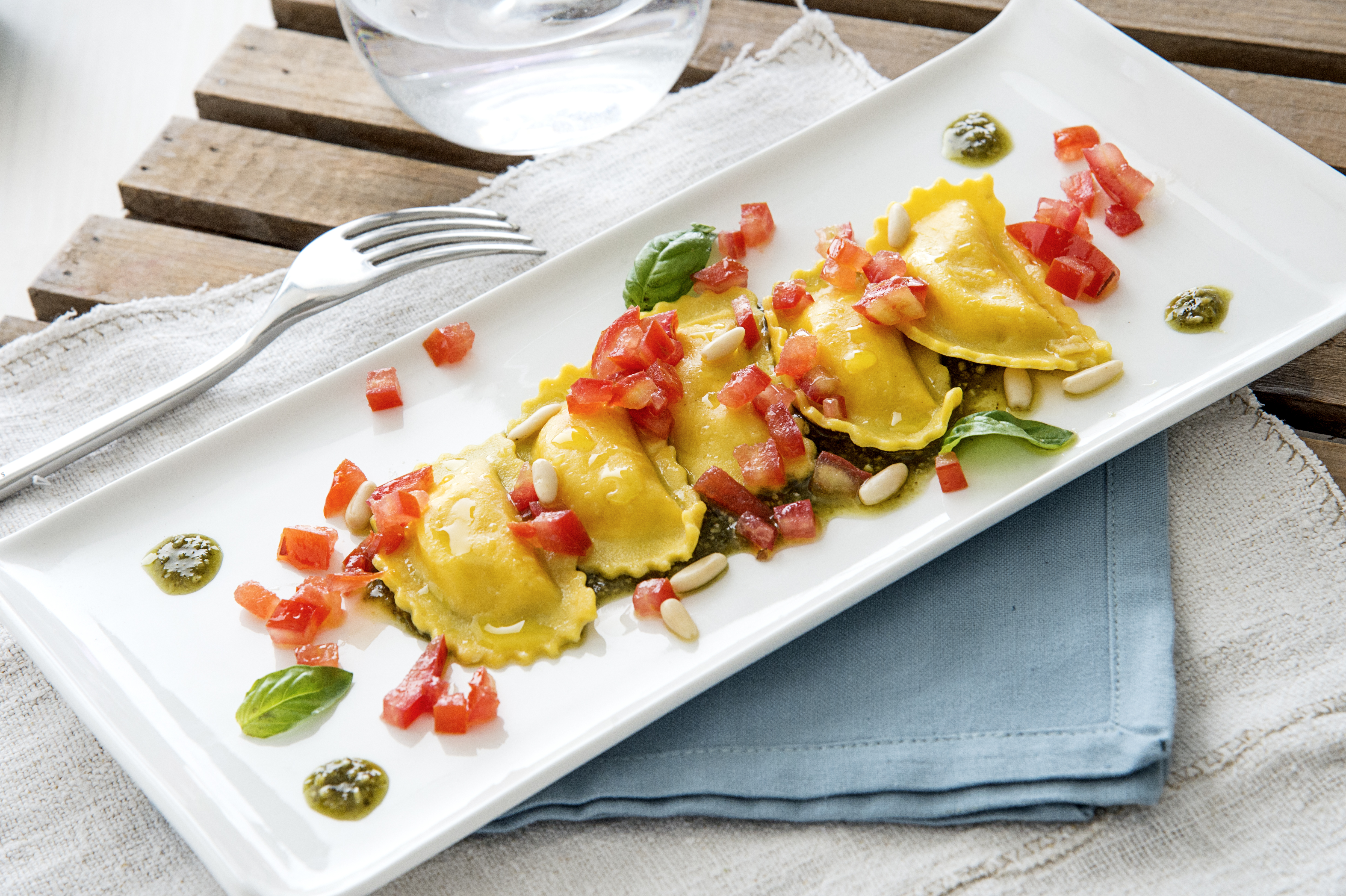 Half moons gluten-free with salmon with basil pesto and fresh tomato concassé