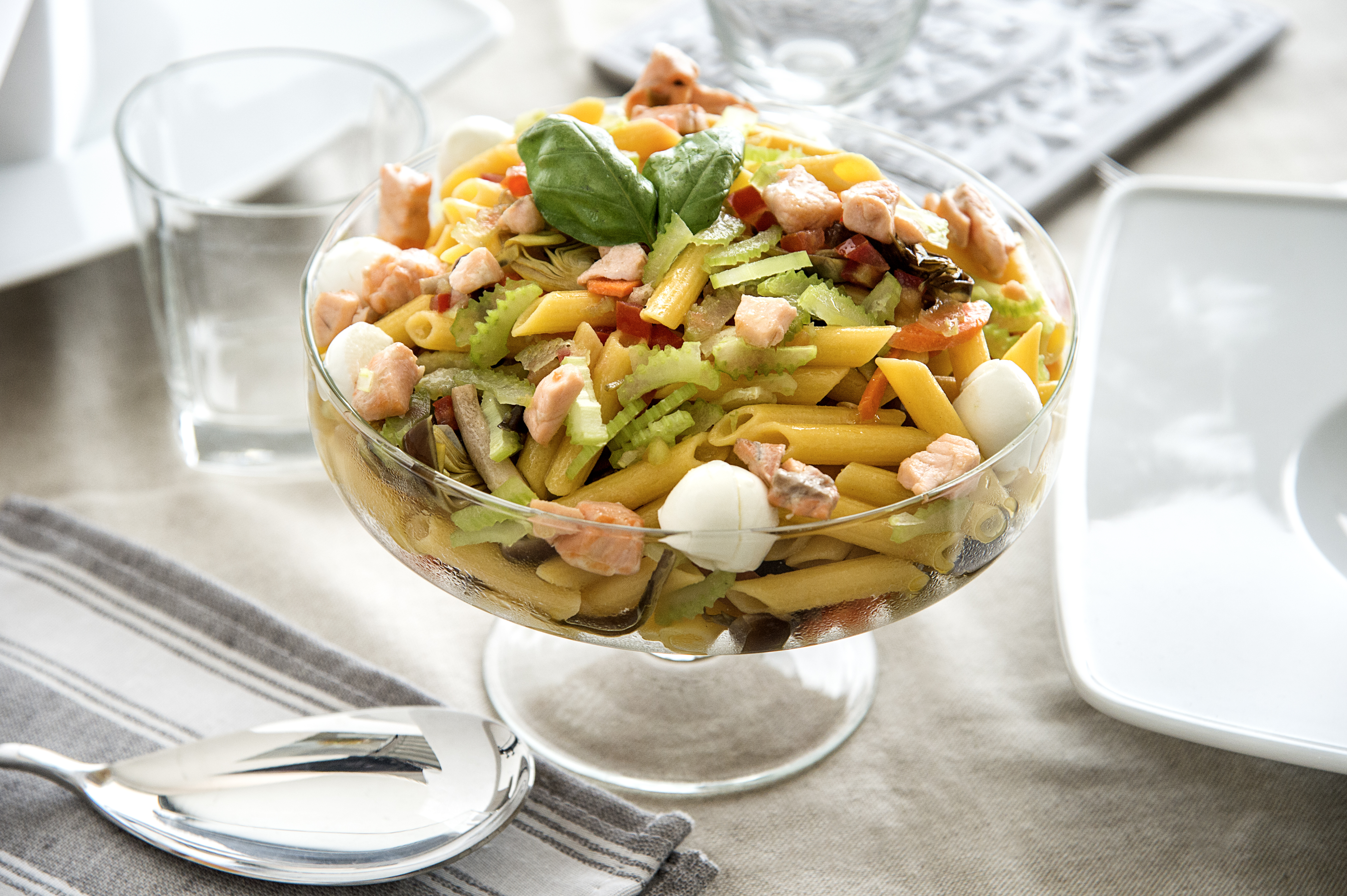 Gluten-free corn penne salad with crunchy vegetables and buffalo mozzarella cherries