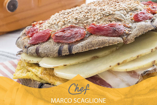 Focaccia de cáñamo sin gluten con tomates cherry, rellena de panqueques, untar tocino y rodajas de patatas escaldadas