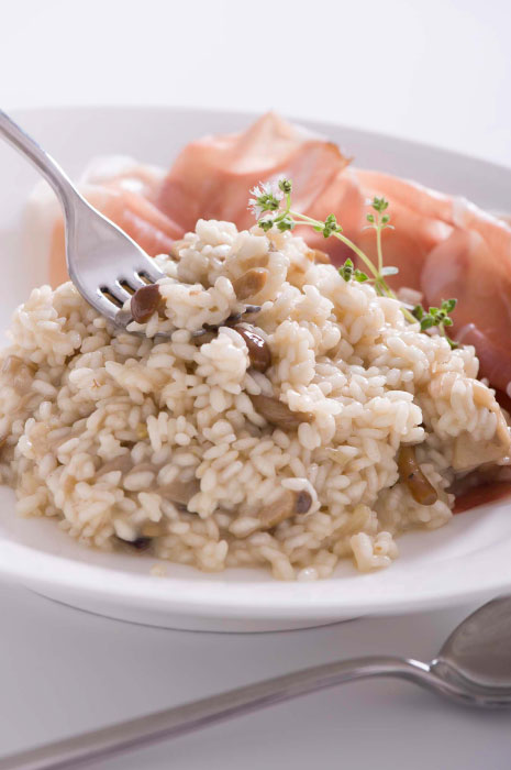 Gluten-free risotto with speck and marjoram mushrooms