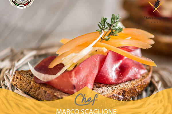 Slice of rustic Saracen bread with bresaola and cruditè of yellow pepper