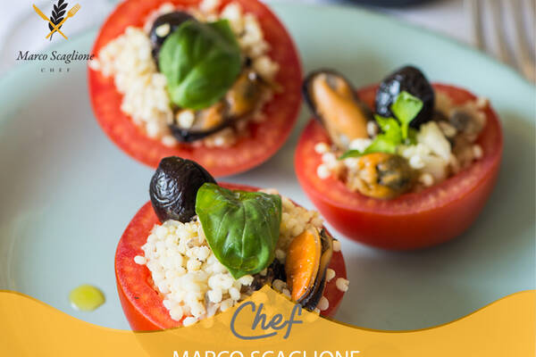Stuffed tomatoes with millet, mussels and clams